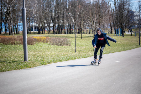 MINSK, BELARUS - 1 MARTH, 2019: children and adults walk in the park and ride roller skates and...