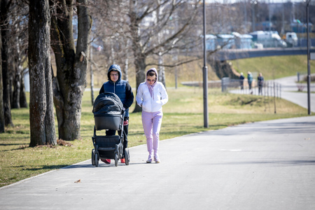 MINSK, BELARUS - 1 MARTH, 2019: children and adults walk in the park and ride roller skates and bicyclesのeditorial素材