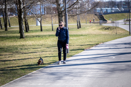 MINSK, BELARUS - 1 MARTH, 2019: children and adults walk in the park and ride roller skates and bicyclesのeditorial素材