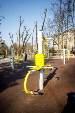 MINSK, BELARUS - 1 MAY, 2019: children, adults and old people exercise on outdoor exercise machinesの写真素材