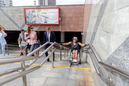 MINSK, BELARUS - 1 JUNE, 2019: a wheelchair user checks the barrier-free environment in the cityのeditorial素材