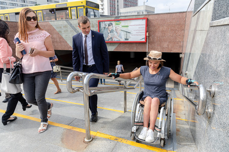 MINSK, BELARUS - 1 JUNE, 2019: a wheelchair user checks the barrier-free environment in the cityのeditorial素材