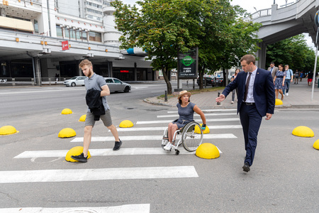 MINSK, BELARUS - 1 JUNE, 2019: a wheelchair user checks the barrier-free environment in the cityのeditorial素材