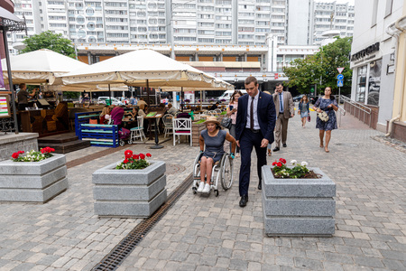 MINSK, BELARUS - 1 JUNE, 2019: a wheelchair user checks the barrier-free environment in the cityのeditorial素材