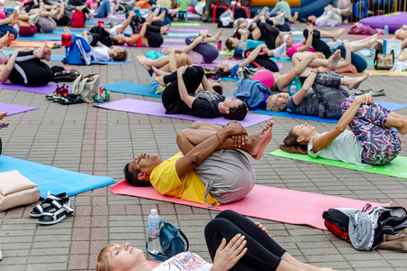 MINSK, BELARUS - 1 JUNE, 2019: many people do yoga in the parkのeditorial素材