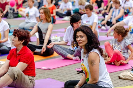 MINSK, BELARUS - 1 JUNE, 2019: many people do yoga in the parkのeditorial素材