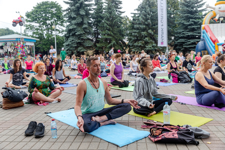 MINSK, BELARUS - 1 JUNE, 2019: many people do yoga in the parkのeditorial素材
