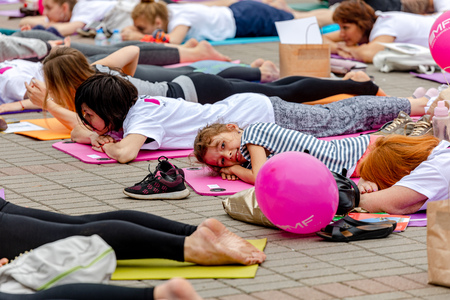MINSK, BELARUS - 1 JUNE, 2019: many people do yoga in the parkのeditorial素材