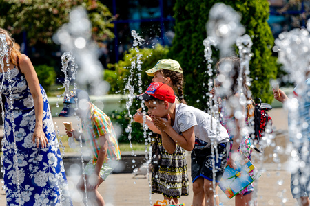 MINSK, BELARUS - 1 JUNE, 2019: children play near the fountain in the city center in summer in hot weatherのeditorial素材