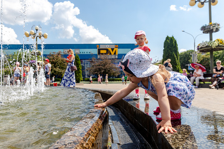 MINSK, BELARUS - 1 JUNE, 2019: children play near the fountain in the city center in summer in hot weatherのeditorial素材