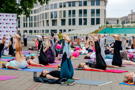 MINSK, BELARUS - 1 JUNE, 2019: many people do yoga in the parkのeditorial素材