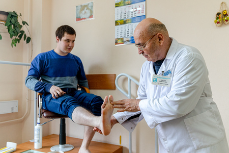 MINSK, BELARUS - 1 JUNE, 2019: man consulting foot doctor in his clinicのeditorial素材