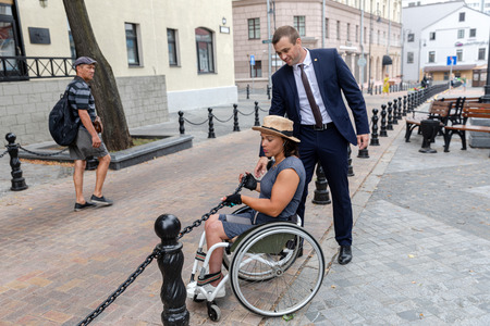 MINSK, BELARUS - 1 JUNE, 2019: a wheelchair user checks the barrier-free environment in the cityのeditorial素材