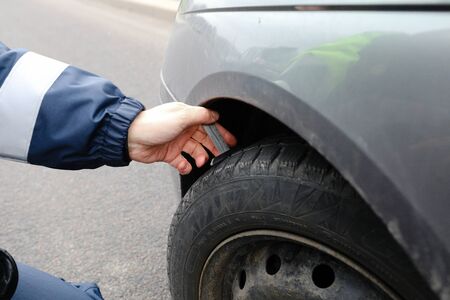 MINSK, BELARUS - February 25, 2020: checking winter tires on an old carの写真素材