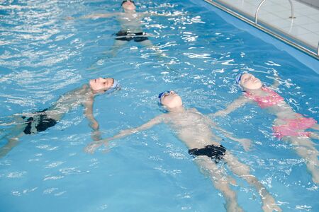MINSK, BELARUS - February 25, 2020: children learn to swim in the poolの写真素材