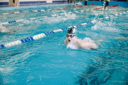 MINSK, BELARUS - February 25, 2020: children learn to swim in the poolの写真素材