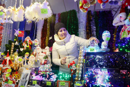 MINSK, BELARUS - February 25, 2020: woman sells Christmas toysのeditorial素材
