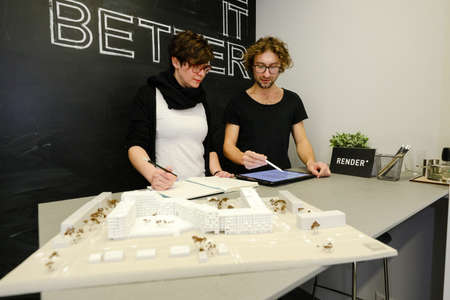 MINSK, BELARUS - February 25, 2020: young architects discussing in office about projectのeditorial素材
