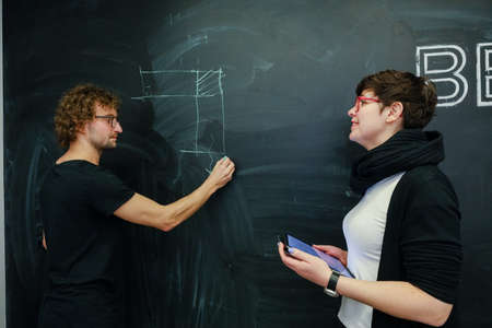 MINSK, BELARUS - February 25, 2020: young architects discussing in office about projectのeditorial素材