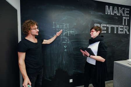 MINSK, BELARUS - February 25, 2020: young architects discussing in office about projectのeditorial素材
