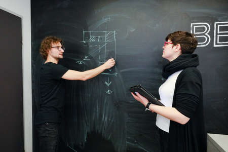 MINSK, BELARUS - February 25, 2020: young architects discussing in office about projectのeditorial素材