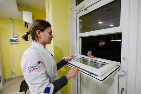MINSK, BELARUS - February 25, 2020: pharmacist in a night pharmacyのeditorial素材