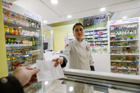MINSK, BELARUS - February 25, 2020: pharmacist in a night pharmacyのeditorial素材