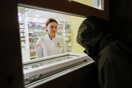 MINSK, BELARUS - February 25, 2020: pharmacist in a night pharmacyのeditorial素材