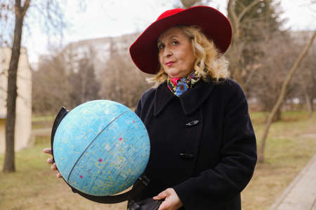 MINSK, BELARUS - February 25, 2020: elderly woman astrologer holding a starry sky globeのeditorial素材