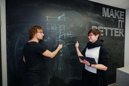 MINSK, BELARUS - February 25, 2020: young architects discussing in office about projectのeditorial素材