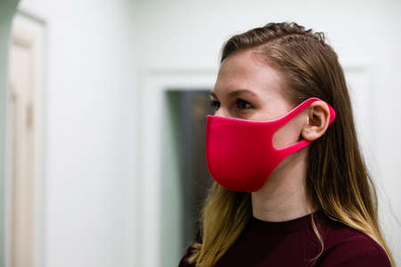 MINSK, BELARUS - 1 MARCH, 2020: young girl puts on a protective mask against coronavirusのeditorial素材