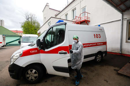 MINSK, BELARUS - 1 MARCH, 2020: woman disinfects ambulance from coronavirusのeditorial素材