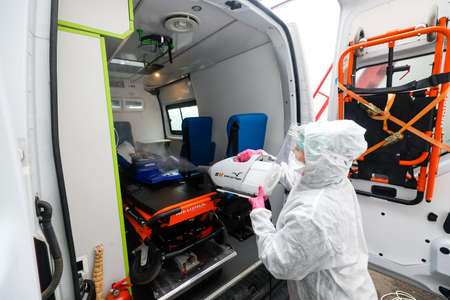MINSK, BELARUS - 1 MARCH, 2020: woman disinfects ambulance from coronavirusのeditorial素材