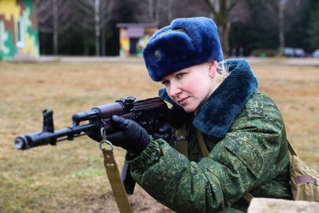 MINSK, BELARUS - 1 MARCH, 2020: woman soldier with gunのeditorial素材
