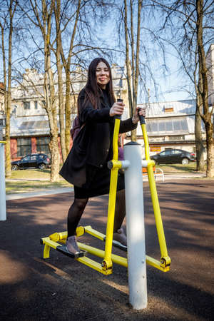 MINSK, BELARUS - 1 MAY, 2019: children, adults and old people exercise on outdoor exercise machinesのeditorial素材