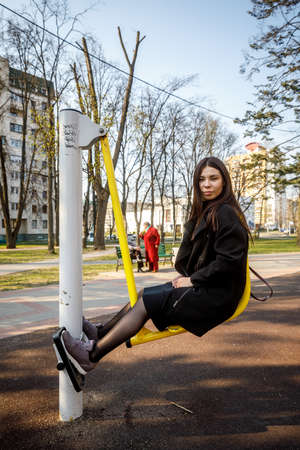 MINSK, BELARUS - 1 MAY, 2019: children, adults and old people exercise on outdoor exercise machinesのeditorial素材