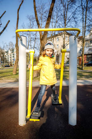 MINSK, BELARUS - 1 MAY, 2019: children, adults and old people exercise on outdoor exercise machinesのeditorial素材