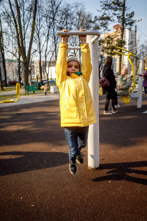 MINSK, BELARUS - 1 MAY, 2019: children, adults and old people exercise on outdoor exercise machinesのeditorial素材