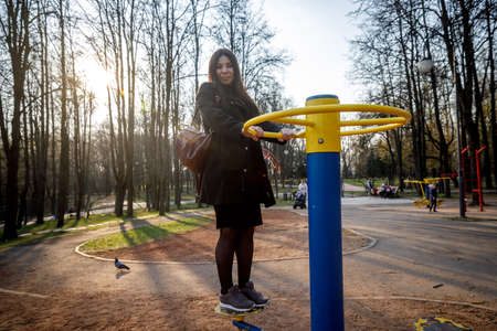 MINSK, BELARUS - 1 MAY, 2019: children, adults and old people exercise on outdoor exercise machinesのeditorial素材