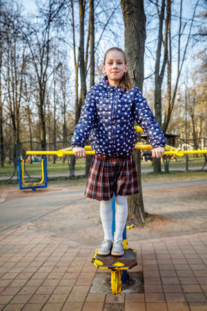 MINSK, BELARUS - 1 MAY, 2019: children, adults and old people exercise on outdoor exercise machinesのeditorial素材