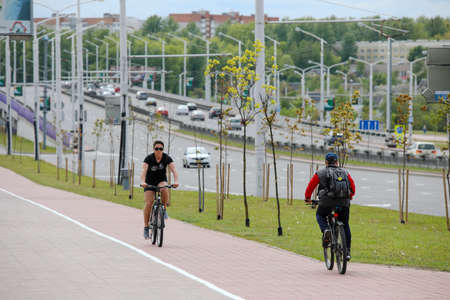 MINSK, BELARUS - 1 OCTOBER, 2020:  man rides a bicycle on a bicycle lane in the city centerのeditorial素材