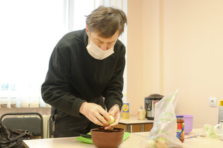 MINSK, BELARUS - 1 March, 2022: blind visually impaired learn to cookの写真素材