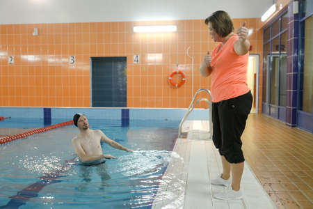 MINSK, BELARUS - 1 March, 2022: Coach teaches swimming in the poolのeditorial素材