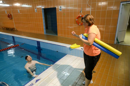 MINSK, BELARUS - 1 March, 2022: Coach teaches swimming in the poolのeditorial素材