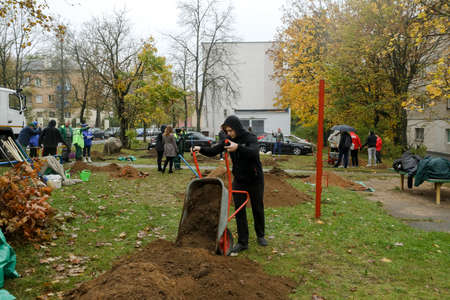 MINSK, BELARUS - 1 March, 2022: people plant trees in their yardのeditorial素材