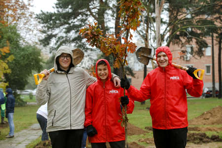 MINSK, BELARUS - 1 March, 2022: people plant trees in their yardのeditorial素材
