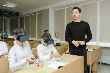 MINSK, BELARUS - 1 March, 2022- schoolchildren use vr at the lessonのeditorial素材