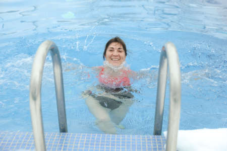 MINSK, BELARUS - 1 March, 2022: Winter swimming in frozen lake ice hole Swimmers wellness in icy water How to swim in cold waterのeditorial素材
