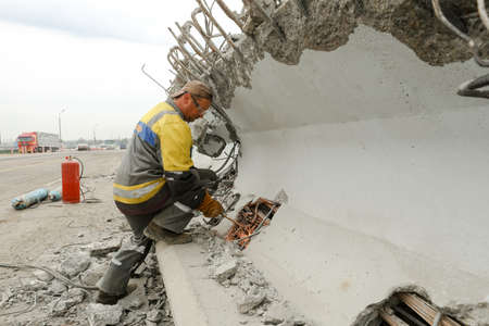 MINSK, BELARUS - 18 FEBRUARY, 2022: workers dismantle and repair the bridgeの写真素材