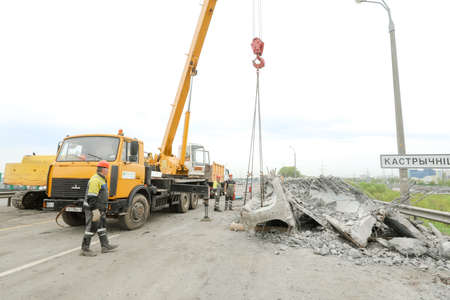 MINSK, BELARUS - 18 FEBRUARY, 2022: workers dismantle and repair the bridgeの写真素材